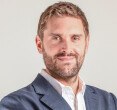 White man with blond hair and beard, looks friendly directly into the camera